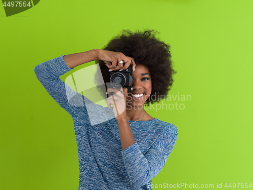 Image of black girl taking photo on a retro camera