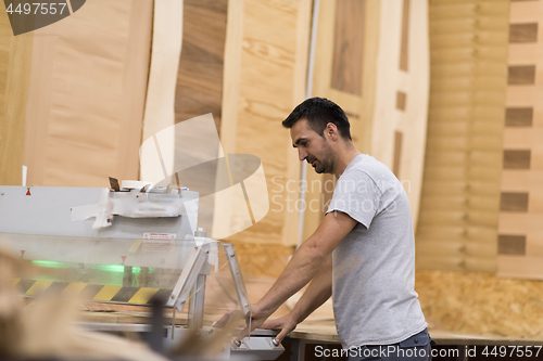 Image of worker in a factory of wooden furniture