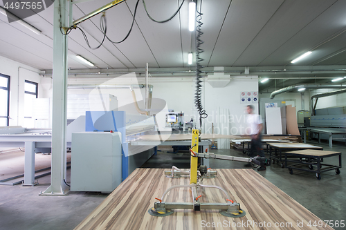 Image of worker in a factory of wooden furniture