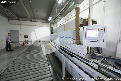 Image of workers in a factory of wooden furniture