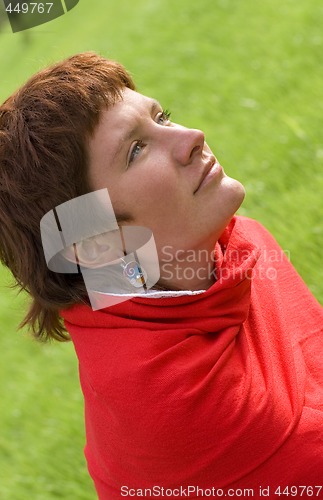Image of redhead woman sitting on the grass