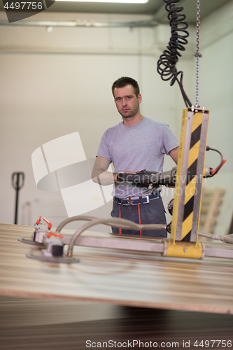 Image of worker in a factory of wooden furniture