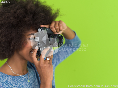 Image of black girl taking photo on a retro camera