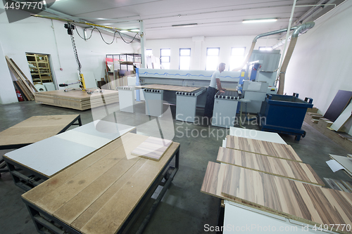 Image of worker in a factory of wooden furniture