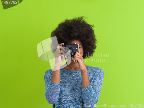 Image of black girl taking photo on a retro camera