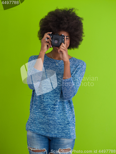 Image of black girl taking photo on a retro camera