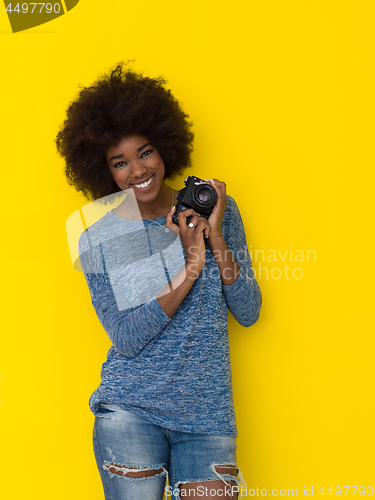 Image of young african american girl taking photo on a retro camera