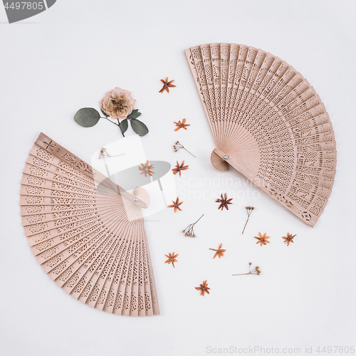 Image of Elegant wooden fans and dried flowers