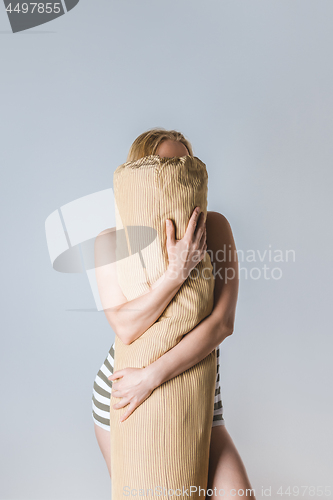 Image of Girl hugging a body pillow