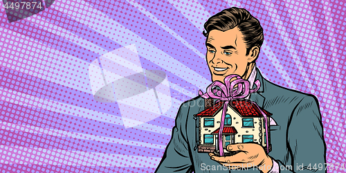 Image of Businessman selling real estate, house as a gift