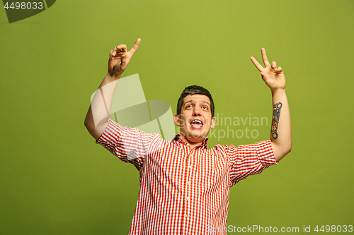 Image of Winning success man happy ecstatic celebrating being a winner. Dynamic energetic image of male model