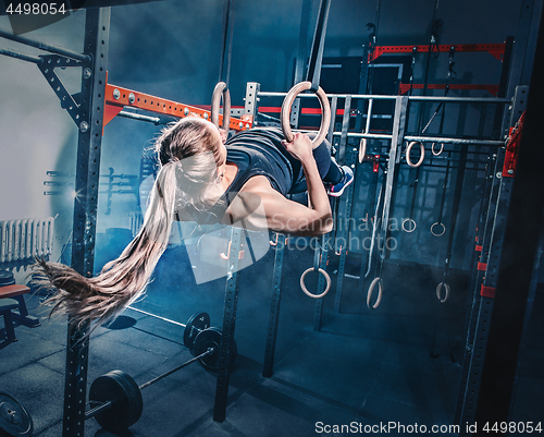 Image of Concept: power, strength, healthy lifestyle, sport. Powerful attractive muscular woman at CrossFit gym