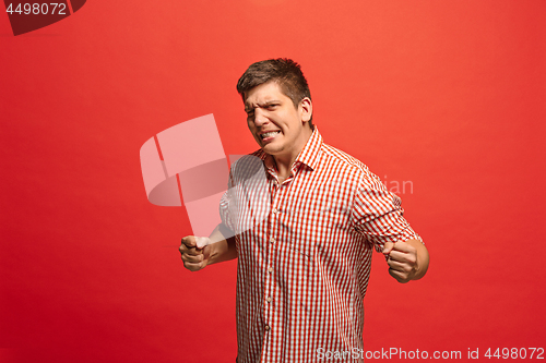 Image of Winning success man happy ecstatic celebrating being a winner. Dynamic energetic image of male model