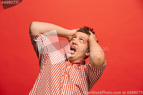 Image of Portrait of the scared man on red