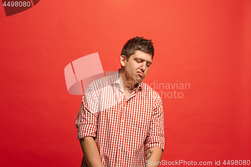 Image of Beautiful bored man isolated on red background