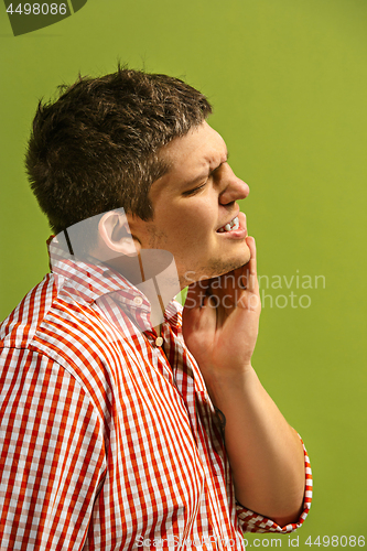 Image of Young man is having toothache.