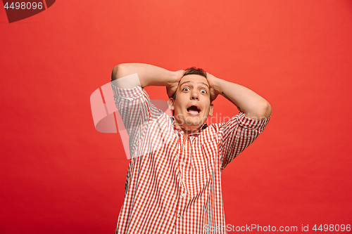 Image of Portrait of the scared man on red