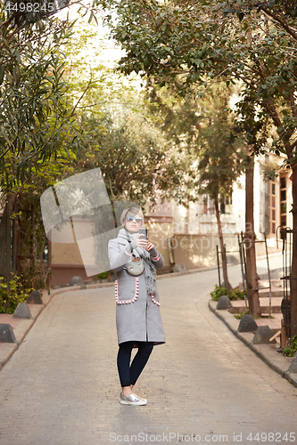 Image of Pretty blonde taking a selfie on a spring day