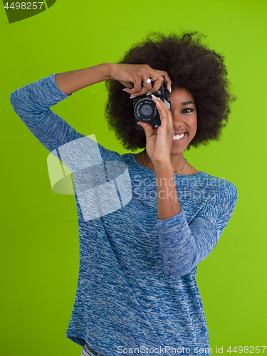 Image of black girl taking photo on a retro camera