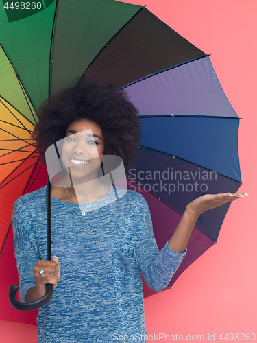 Image of afro american woman holding a colorful umbrella