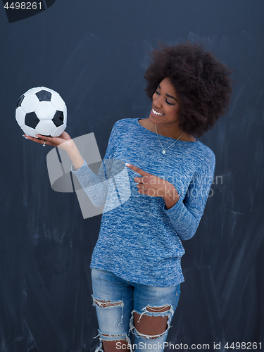 Image of black woman holding a soccer bal