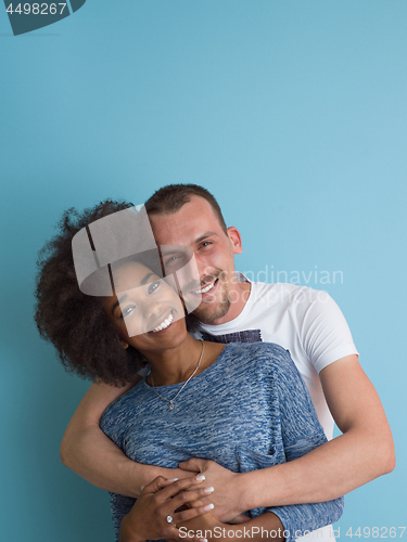 Image of multiethnic couple laughing and hugging