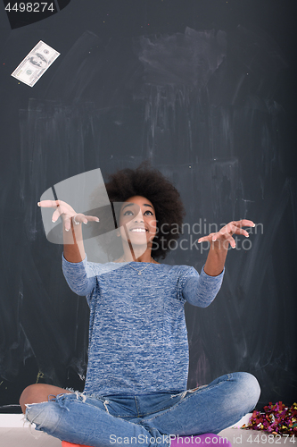 Image of black woman throwing money