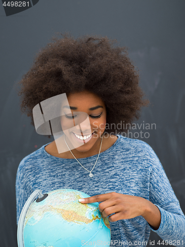 Image of black woman holding Globe of the world