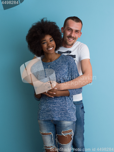 Image of multiethnic couple laughing and hugging