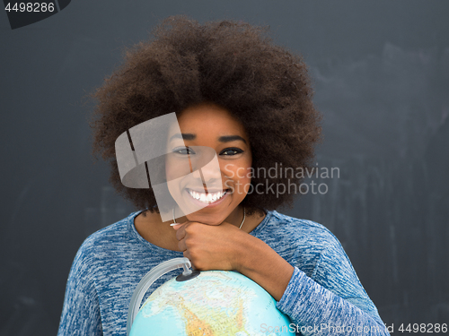 Image of black woman holding Globe of the world