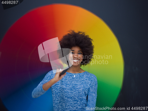 Image of african american woman holding a colorful umbrella