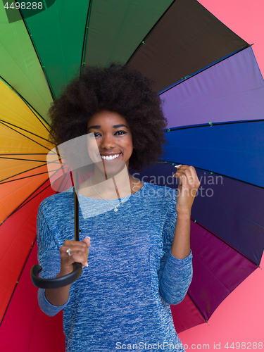 Image of afro american woman holding a colorful umbrella