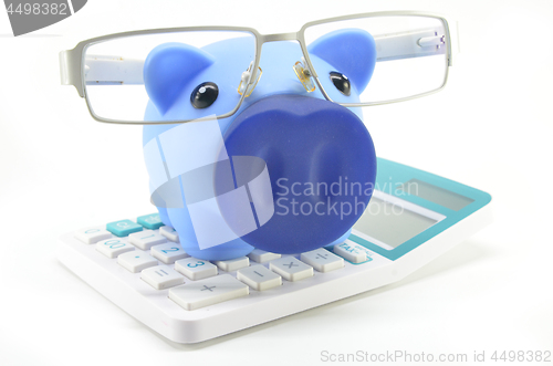 Image of Piggybank with eyeglasses and calculator 