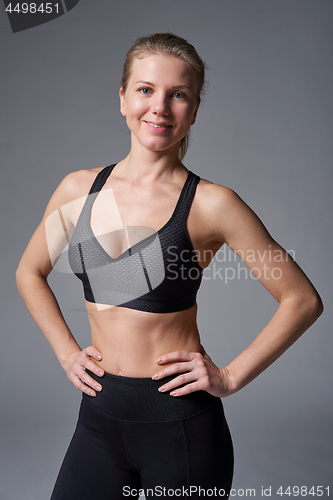 Image of Sport athletic woman standing with hands on hips