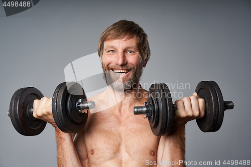 Image of mature man shirtless standing with dumbbells