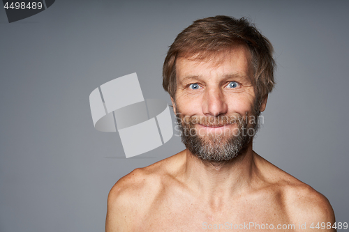 Image of mature man shirtless standing smiling at camera