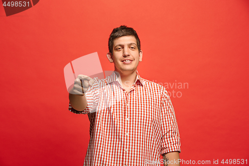 Image of The overbearing businessman point you and want you, half length closeup portrait on red background.