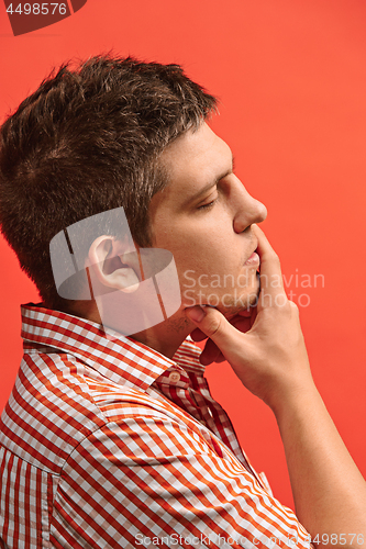 Image of Young serious thoughtful businessman. Doubt concept.