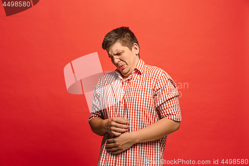 Image of Let me think. Doubtful pensive man with thoughtful expression making choice against red background