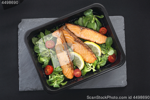 Image of Pieces of baked salmon on lettuce