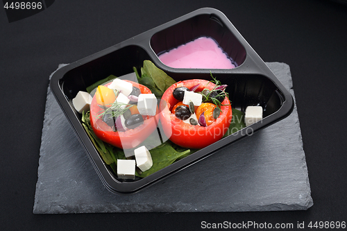 Image of Prepared dish, stuffed tomatoes with pink yoghurt sauce