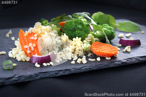 Image of Dinner dish, rice with broccoli and carrots.