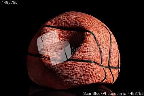 Image of Deflated and rumpled old basketball ball