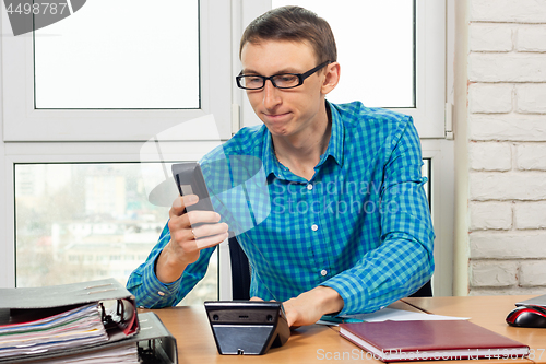 Image of Office worker dials the phone number