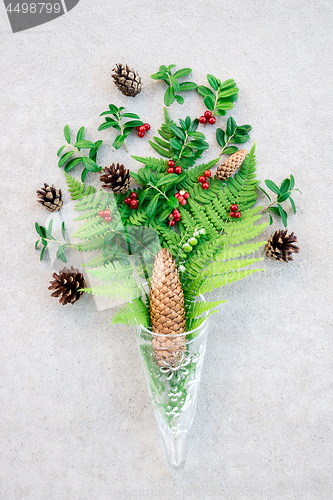 Image of Glass cone with wild forest plants and berries