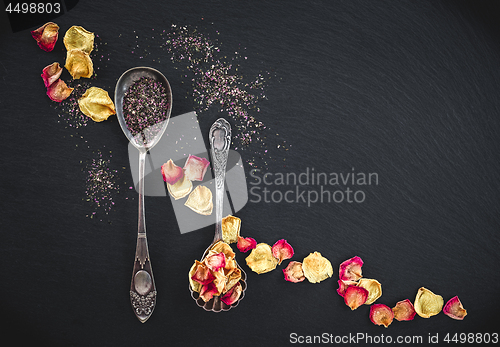 Image of Silver spoons with floral tea and rose petals