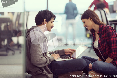 Image of software developers couple working on the floor