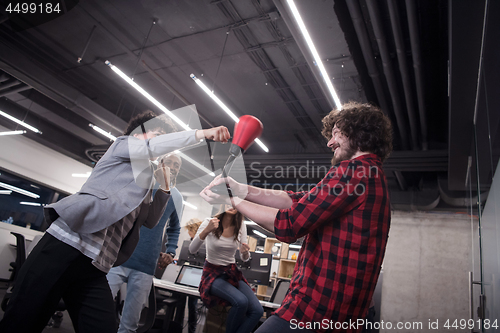 Image of multiethnics business team boxing at office