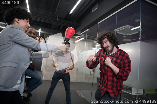 Image of multiethnics business team boxing at office