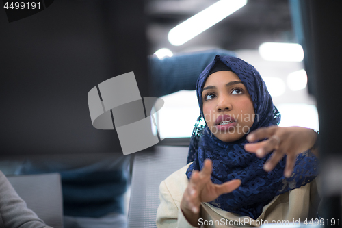 Image of black muslim female software developer at work